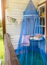 Table set on country home balcony  protected by mosquito net  to keep away annoying bugs. Royalty Free Stock Photo