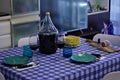 Table set with dishes, glasses and a bottle of red wine near salami and bread Pesaro, Italy Royalty Free Stock Photo