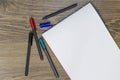 On the table is a set for drawing: four markers and a white sheet of paper Royalty Free Stock Photo