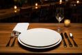 Table set. Empty white plates and cutlery on old rustic wooden table in restaurant Royalty Free Stock Photo
