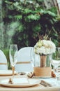 Table set for an event party or wedding reception banquet. Winter bridal bouquet of white carnations, peony, roses Royalty Free Stock Photo