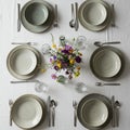 Table set for four with ceramic bowls and plates featuring a speckled design on a Royalty Free Stock Photo