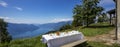 Table set imn outdoors with a large white tablecloth and a view of Lake Maggiore Royalty Free Stock Photo