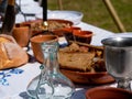 table set for outdoor medieval dining in a park during a festival