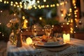 A table set with a plate of food and two glasses of wine, showcasing a delicious meal ready to be enjoyed, A romantic Italian