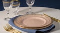a table set with a plate, silverware, and a glass of water with gold rims and a blue napkin with a gold rim