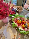 a table set with plates of food, a plate with cold meats and cheeses, a plate with fruit