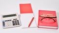 Table set purchasing Manager: glasses, calculator, Notepad, pen, and a directory of suppliers