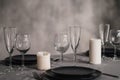 A table set in the restaurant. Serving a table. Grey artistic background. Black matte utensils, glass glasses. White Royalty Free Stock Photo