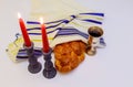 table set for Shabbat with lighted candles, challah bread and wine. Royalty Free Stock Photo