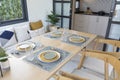 Table set on table with yellow plate setting in modern style dining room Royalty Free Stock Photo