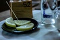 Table set up in a restaurant. narrow frame with objects that are usually found in a restaurant such as beverage glasses etc.