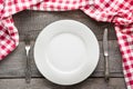 Table set with white plate with knife and fork with red napkin around . Royalty Free Stock Photo