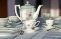 Fine porcelaine cup, jug and silver cutlery on table