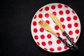 Table setting with a bamboo knife, fork and plate with polka dot Royalty Free Stock Photo