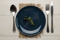 Table setting. Blue plate and Cutlery, fork, spoon and knife on a white wooden table. top view Royalty Free Stock Photo