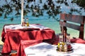 Table setting with bottles of olive oil and vinegar at tropical beach restaurant Royalty Free Stock Photo