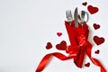 Table setting for celebration Valentine`s Day. table place setting and cutlery, napkin with red hearts for Valentine day.