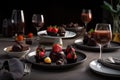 table setting with chocolate-covered strawberries, glass of red wine, and plate of assorted desserts