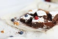 Table setting, chocolate dessert brownie cake with berries on pa Royalty Free Stock Photo