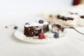 Table setting, chocolate dessert brownie cake with berries Royalty Free Stock Photo