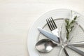 Table setting. cutlery. Fork, knife, glass, spoon and plate on a white wooden table. top view Royalty Free Stock Photo