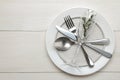 Table setting. cutlery. Fork, knife, glass, spoon and plate on a white wooden table. top view Royalty Free Stock Photo