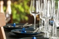 Table setting with empty glasses, plates and cutlery. Space for text