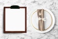 Table setting and empty menu on marble background, flat lay. Space for text Royalty Free Stock Photo