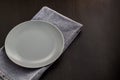 table setting with empty plate and napkin on black background copyspace Royalty Free Stock Photo