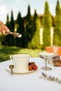 Table setting, female hand puts sugar into a cup Royalty Free Stock Photo