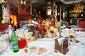 table setting for a festive dinner. flowers, wine glasses, tableware and snacks.