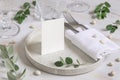 Table setting with folded card decorated with eucalyptus branches close up, Wedding mockup Royalty Free Stock Photo