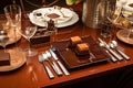 table setting with gourmet chocolate bars, cutlery, and glassware for elegant dessert