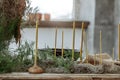 Table setting with Handmade candles on rustic old wood table and wood accessories in earth tones boho style Royalty Free Stock Photo