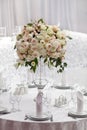 Table setting at a luxury wedding reception. Beautiful flowers on the table.