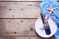 Table setting in ocean style on aged wooden background. Royalty Free Stock Photo