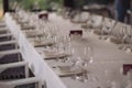 Table setting for a party or wedding reception in a restaurant. Row of ladder-back chairs set Royalty Free Stock Photo