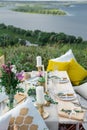 Decorated elegant wooden table in rustic style with eucalyptus and flowers, porcelain plates, glasses, napkins and cutlery Royalty Free Stock Photo