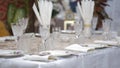 Table setting. Plates are beautifully placed on a festive home table. Dinner dishes and glasses are placed on the table. Royalty Free Stock Photo