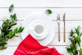 Table setting with plates, flatware and flower on white wooden background top view Royalty Free Stock Photo