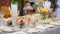 Table setting. Plates with snacks are beautifully placed on the festive home table. Dinner dishes and glasses are placed Royalty Free Stock Photo