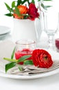 Table setting with red buttercup flowers Royalty Free Stock Photo