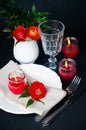 Table setting with red buttercups on a black background Royalty Free Stock Photo