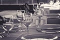 Table setting in restaurant. Empty wine glasses, plates, forks, knifes on the tablecloth. Elegant restaurant interior. Royalty Free Stock Photo