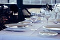Table setting in restaurant. Empty wine glasses, plates, forks, knifes on the tablecloth. Elegant restaurant interior. Royalty Free Stock Photo