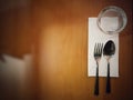 Table setting with retro vintage low key light theme. fork and spoon, napkin, tissue, glass with copy space for label text, top