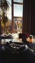 Table setting for romantic breakfast in the morning sun through a French window. Shadows and sunbeams in dark room