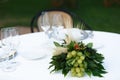 Table setting for a romantic dinner. Bouquet with bunches of grapes ,laurel leaves