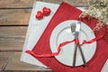 Table setting for a romantic dinner with two hearts, pate and cutlery on red and white napkins, love concept, rustic wooden table Royalty Free Stock Photo